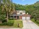 Inviting two-story home with brick facade, front porch, manicured lawn, and two-car garage at 5488 Altamaha Dr, North Charleston, SC 29420