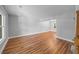 Open concept living room featuring hardwood floors, neutral paint, and natural light from large windows at 5488 Altamaha Dr, North Charleston, SC 29420