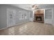 Bright living room featuring a brick fireplace, built-in shelving, and tile flooring, great for gatherings at 5488 Altamaha Dr, North Charleston, SC 29420