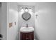 Stylish powder room with a dark wood vanity, oval mirror, and modern lighting at 5488 Altamaha Dr, North Charleston, SC 29420