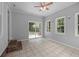 Relaxing sunroom featuring tile floors, a ceiling fan, and a sliding glass door to the backyard at 5488 Altamaha Dr, North Charleston, SC 29420
