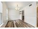 Bright dining area featuring wood-look floors, a modern chandelier, and fresh white walls at 655 Swinton Ct, Mount Pleasant, SC 29464