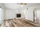 Spacious living room featuring a brick fireplace, ceiling fan, and light-colored walls at 655 Swinton Ct, Mount Pleasant, SC 29464