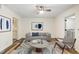 Open living room with ceiling fan, a couch, accent chair, and adjacent access to the kitchen and laundry area at 655 Swinton Ct, Mount Pleasant, SC 29464