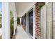 Inviting porch with brick siding and pillars offering a glimpse of the manicured landscaping at 655 Swinton Ct, Mount Pleasant, SC 29464