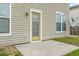 Backyard exterior featuring a concrete patio, yellow door, vinyl siding, and several windows at 7675 High Maple Cir, North Charleston, SC 29418