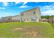 Beautifully maintained backyard with lush green grass and a view of the home's exterior and fence at 7675 High Maple Cir, North Charleston, SC 29418