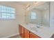 Bathroom with a double sink vanity, a large mirror, and natural light from a window at 7675 High Maple Cir, North Charleston, SC 29418