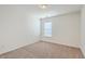 Simple carpeted bedroom with a window and neutral walls, ready for personalization at 7675 High Maple Cir, North Charleston, SC 29418