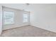 Neutral carpeted bedroom featuring natural light from two windows at 7675 High Maple Cir, North Charleston, SC 29418