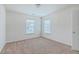 Carpeted bedroom with natural light streaming through the two windows at 7675 High Maple Cir, North Charleston, SC 29418