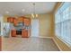 Bright dining area featuring cherry cabinets, stainless steel appliances, and a large window at 7675 High Maple Cir, North Charleston, SC 29418