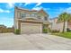 Well-maintained home featuring a stone-accented garage, solar panels, and a paved driveway at 7675 High Maple Cir, North Charleston, SC 29418
