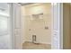 Spacious laundry room featuring tile flooring, washer/dryer hookups, and a convenient wire shelf for storage at 7675 High Maple Cir, North Charleston, SC 29418