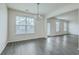 This living room is bright, with lots of windows, and a modern gray wood-look floor at 7675 High Maple Cir, North Charleston, SC 29418