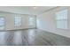 Spacious living room with lots of natural light, and wood-look flooring at 7675 High Maple Cir, North Charleston, SC 29418