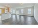 Bright living space with wood-look flooring, connecting seamlessly to the kitchen at 7675 High Maple Cir, North Charleston, SC 29418