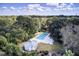 Aerial view of community pool surrounded by mature trees, with a pool house nearby at 828 Bridge Point Cir, Mount Pleasant, SC 29464