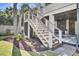Elevated deck staircase with wire railing descending into a landscaped backyard. Plenty of shade to relax at 828 Bridge Point Cir, Mount Pleasant, SC 29464