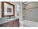Bright bathroom featuring marble tiled shower, decorative mirror, and granite countertop at 828 Bridge Point Cir, Mount Pleasant, SC 29464