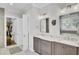 Bathroom with double vanity, marble countertops, modern lighting and a walk-in closet at 828 Bridge Point Cir, Mount Pleasant, SC 29464