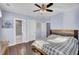 Spacious bedroom with light blue walls, ceiling fan, and ensuite bathroom entrance at 828 Bridge Point Cir, Mount Pleasant, SC 29464