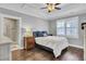 Bedroom boasts tray ceilings, hardwood floors, and a lovely ensuite bathroom with a glass-enclosed shower at 828 Bridge Point Cir, Mount Pleasant, SC 29464