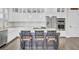 Kitchen island with seating and stylish pendant lights, plus stainless steel appliances, and beautiful custom cabinets at 828 Bridge Point Cir, Mount Pleasant, SC 29464