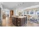 The kitchen island has bar seating with granite countertops, hardwood floors, and is situated near the breakfast nook at 828 Bridge Point Cir, Mount Pleasant, SC 29464