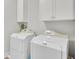 Well-equipped laundry room featuring white appliances and cabinet storage at 828 Bridge Point Cir, Mount Pleasant, SC 29464