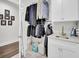 Organized laundry space with sink, cabinets, and hanging storage for clothing at 828 Bridge Point Cir, Mount Pleasant, SC 29464