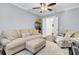 Bright living room with neutral decor, ceiling fan, and open doorway to another room at 828 Bridge Point Cir, Mount Pleasant, SC 29464