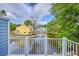 Scenic backyard view of the community's pond from the white fenced balcony at 851 Sandlake Dr # D, Mount Pleasant, SC 29464
