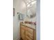 Compact bathroom features a granite countertop, decorative oval mirror, and soft lighting, creating a functional and stylish space at 851 Sandlake Dr # D, Mount Pleasant, SC 29464