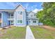 Blue two-story condo with lush green grass and matching blue door at 851 Sandlake Dr # D, Mount Pleasant, SC 29464