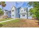 Charming blue two-story townhome featuring shingle and siding accents, well-manicured landscaping, and a welcoming entryway at 851 Sandlake Dr # D, Mount Pleasant, SC 29464