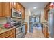Efficient kitchen featuring wood cabinets, stainless appliances, granite countertops, and an open view to the living area at 851 Sandlake Dr # D, Mount Pleasant, SC 29464