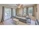 Cozy living room featuring a comfortable sofa, sliding doors for light, ceiling fan, and neutral decor at 851 Sandlake Dr # D, Mount Pleasant, SC 29464