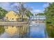 Serene pond reflects the architecture of townhomes, providing a tranquil environment with natural beauty at 851 Sandlake Dr # D, Mount Pleasant, SC 29464