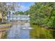 Picturesque pond with a fountain in front of two-story townhomes with balcony and scenic waterfront views at 851 Sandlake Dr # D, Mount Pleasant, SC 29464