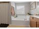 Bathroom featuring a large soaking tub, window and tile flooring at 9206 Southern Oak Lane Ln, Ladson, SC 29456