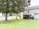Lush backyard features mature trees, screened porch, and ample space for recreation at 9229 N Moreto Cir, Summerville, SC 29485