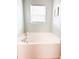 Bathroom features a drop-in tub under a window with privacy blinds and green paint at 9229 N Moreto Cir, Summerville, SC 29485