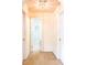 Hallway with carpet leading to a doorway that reveals a bathroom with a vanity and toilet at 9229 N Moreto Cir, Summerville, SC 29485