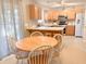 Bright kitchen with wood cabinets, an island counter with chairs, and stainless steel appliances at 9229 N Moreto Cir, Summerville, SC 29485