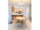 Cozy kitchen with wooden cabinets, laminate countertop, and round table with four chairs near sliding glass door at 9229 N Moreto Cir, Summerville, SC 29485