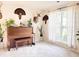 Well-lit living room with a piano, plants, and decorative wall art at 9229 N Moreto Cir, Summerville, SC 29485