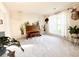Cozy living room with a piano, plants, and natural light from the window at 9229 N Moreto Cir, Summerville, SC 29485