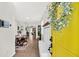 Inviting entryway featuring a bright yellow door, coat rack, and a view into the dining area at 9712 Fanning Basket Ln, Ladson, SC 29456