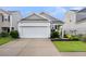 Charming home featuring a two-car garage, yellow front door, and well-maintained landscaping at 9712 Fanning Basket Ln, Ladson, SC 29456